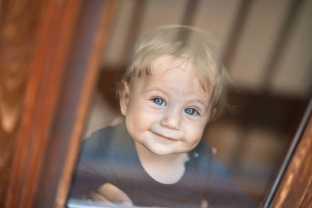Baby boy near window