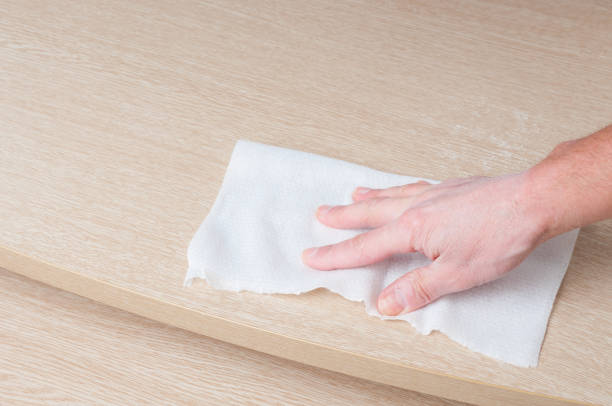 istock Hand cleaning of wooden table with paper towel 1216423607