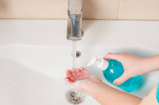 istock Washing hands with liquid soap under faucet 1216425092