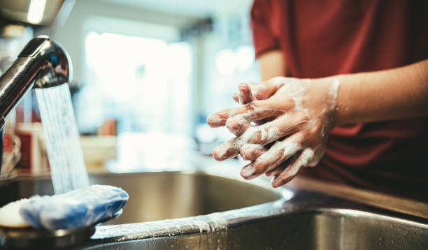 istock COVID-19, Teenager's hands washing during lockdown 1216425353
