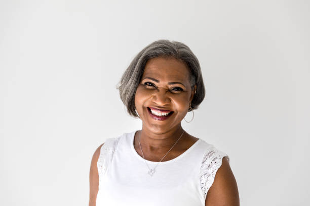 Portrait of healthy African American senior woman A happy African American senior woman smiles confidently at the camera. grandma portrait stock pictures, royalty-free photos & images