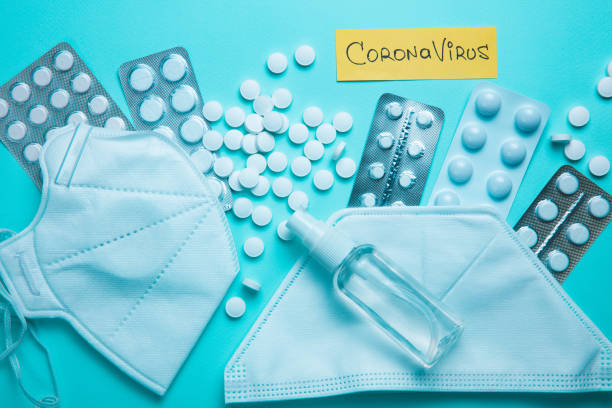 istock Coronavirus phrase text on a blue background with pills, sanitizer 1216426753