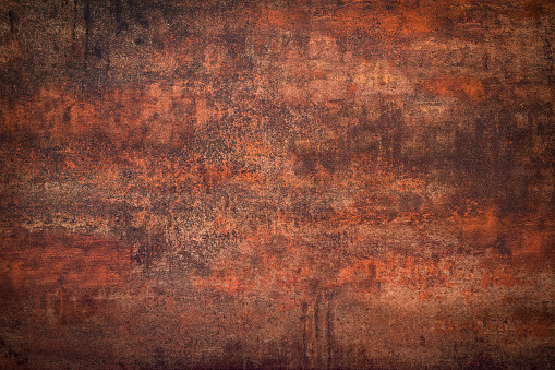 Close-up of an rusty distressed dark wall. Aging process concept.