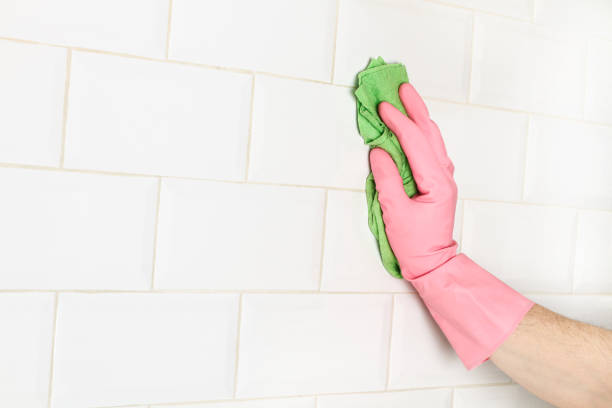 istock Man cleaning with a sponge cloth a wall 1216428287