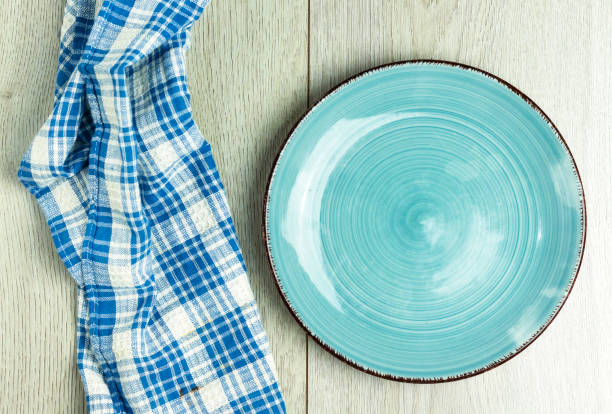 istock Empty plate and napkin on  wooden table. 1216428328