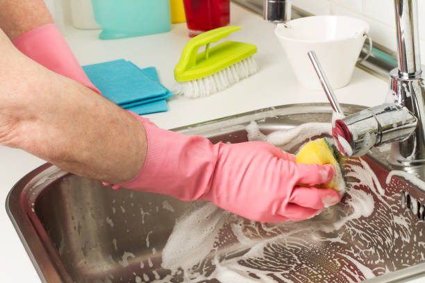 istock Man cleaning with a sponge cloth a sink 1216428404
