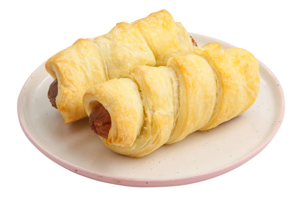 Crispy pies sausages on a plate on a White background