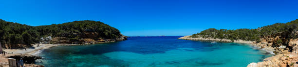 Ibiza, Spain - May 2, 2016: Cala Salada and Cala Saladeta two beaches in the municipality of San Antonio on the island of Ibiza. With little construction around there are two the most unspoilt beaches on the island. This small bay is ideal for anchoring and water sports as they are very protected from bad weather