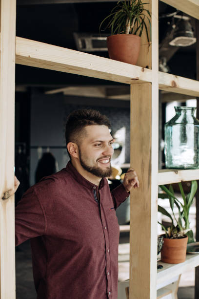 istock Young bearded man student smiling at home 1216430732