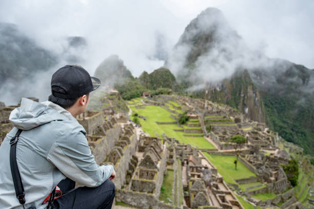 istock Young Asian man traveler looking at Machu Picchu 1216430908