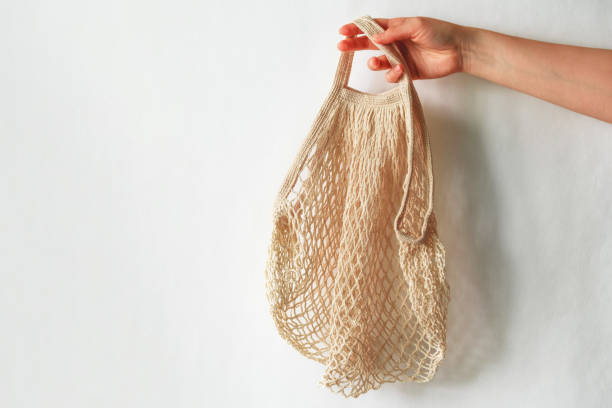 istock female hand holding string back against white wall copy space 1216431060