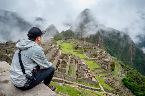 istock Young Asian man traveler looking at Machu Picchu 1216431234