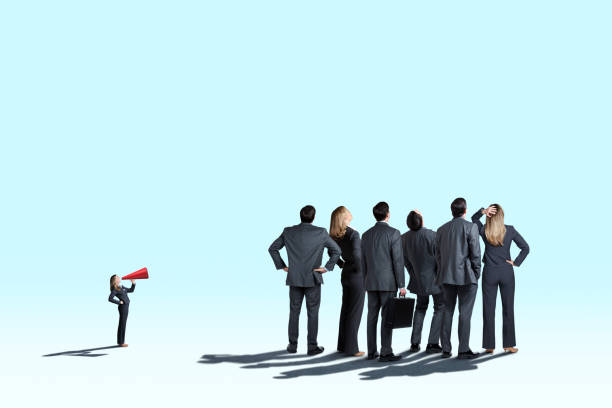 istock Woman Shouting At Group Of People Through Megaphone 1216432507