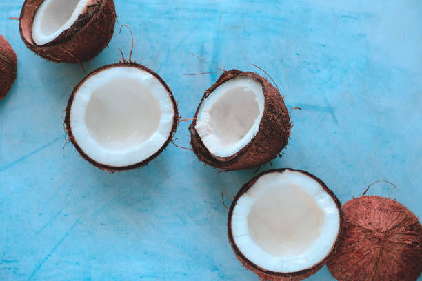 istock coconut halves  on a blue background 1216434893