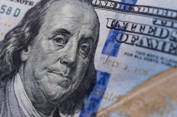 Benjamin Franklin on a 100 US dollars bill. Concept of recession and worldwide economic crisis. stock photo