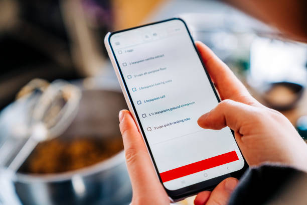 istock Reading food recipe online on mobile phone while cooking 1216435378