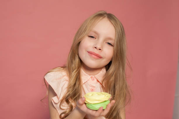 istock Little girl eats sweet cake with cream 1216435626