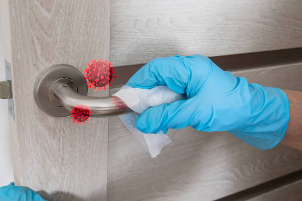 Wiping door knob with antibacterial disinfecting wipe for killing coronavirus. Coronavirus COVID-19 Wiping door knob with antibacterial disinfecting wipe for killing coronavirus. Coronavirus COVID-19. House cleaning and cleanliness surface disinfection stock pictures, royalty-free photos & images