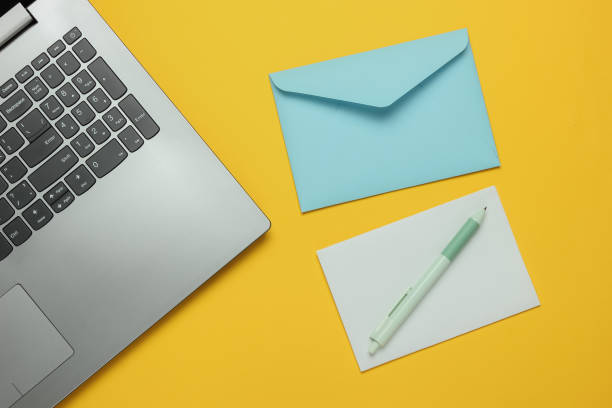istock Laptop and envelope with letter on yellow background. Valentine's day. Top view 1216436505