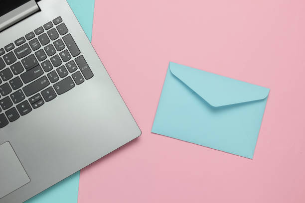 istock Laptop and envelope on pink blue pastel background. Valentine's day. Top view 1216436531