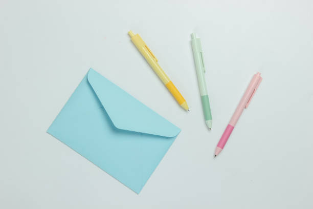istock Envelope and colored pens on a white background. Top view 1216436532