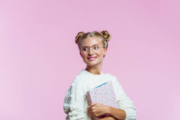 istock Beautiful teenege girl holding pink diary 1216437946