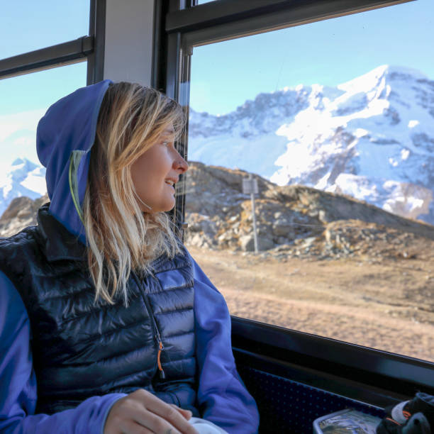 istock Female mountain biker looks out train window 1216439459
