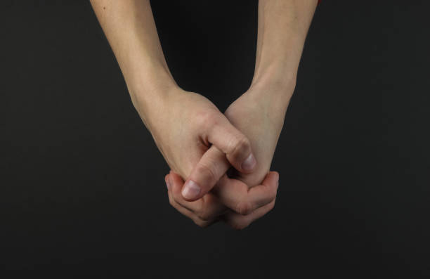 istock Female hand on a black background. Lock of hands 1216439629