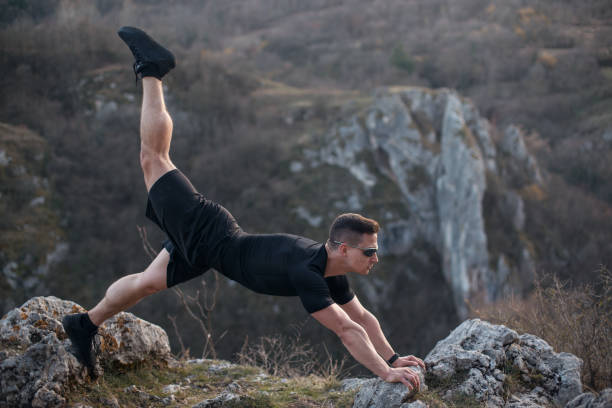 istock Young man exercising on the mountain 1216440413
