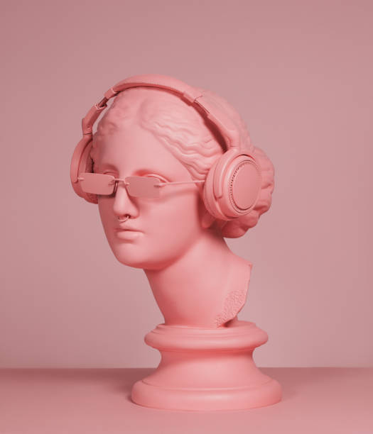 Pink colored modern Greek Goddess with headphones Pink toned plaster head model (mass produced replica of Head of Aphrodite of Knidos) with headphones and sunglasses statue stock pictures, royalty-free photos & images