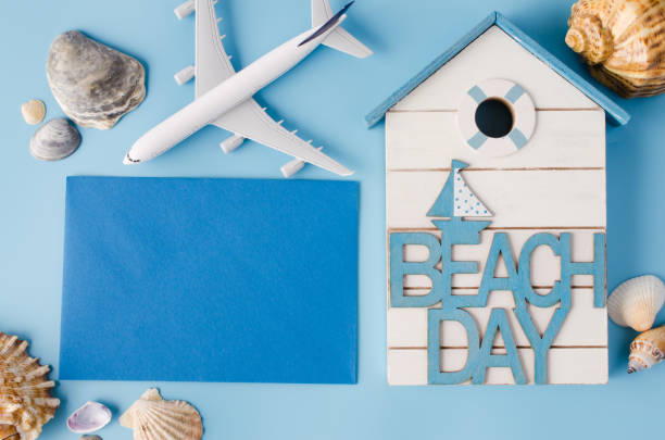 istock Empty blue paper with seashells and decorative airplane. Summer travel concept. 1216442494