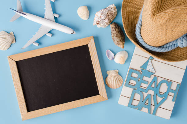 istock Empty chalkboard with seashells and decorative airplane. Summer travel concept. 1216442598