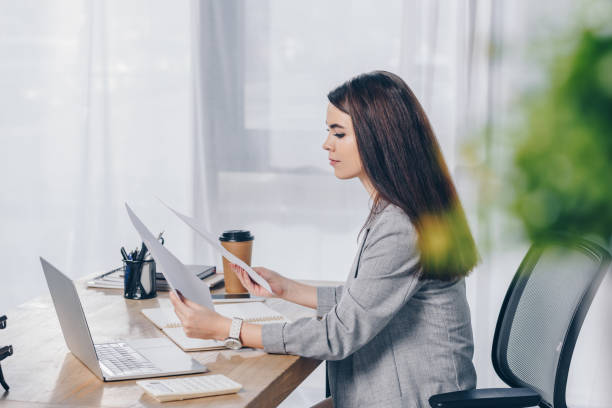 istock Selective focus of recruiter holding papers at table in office 1216444200