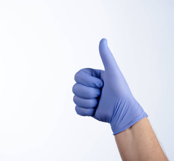 istock Right hand in blue glove, thumb up 1216445007
