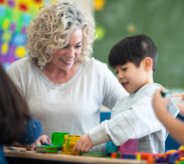 istock Teacher Helping a Student Build a Structure stock photo 1216445106