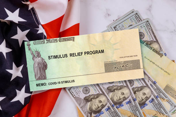 istock Federal STIMULUS RELIEF PROGRAM individual checks virus economic stimulus plan US 100 dollar bills currency on American flag Global pandemic Covid 19 lockdown 1216445913