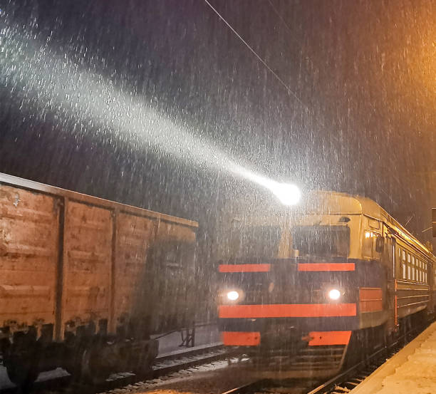 istock Evening train arrives at station. Snowfall complicates transportation of passengers, snow blockades. Blizzard and Snow drifts 1216445990