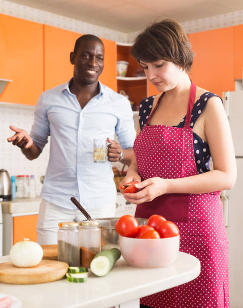 istock Male and female making dinner 1216446333