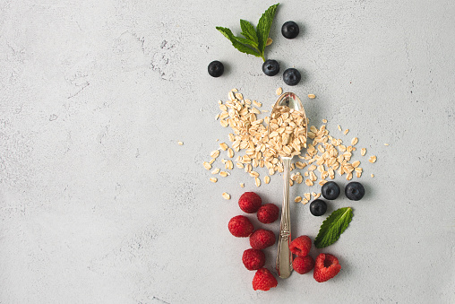 Oatmeal,Raspberries, Strawberries and blueberries in flat lay design.