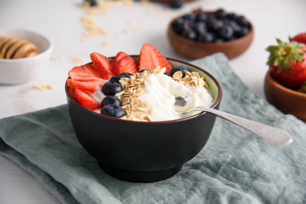 Bowl of yogurt with berries and oatmeal stock photo
