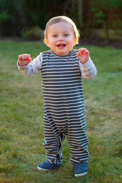 istock Baby boy 10 months old standing on grass 1216450108