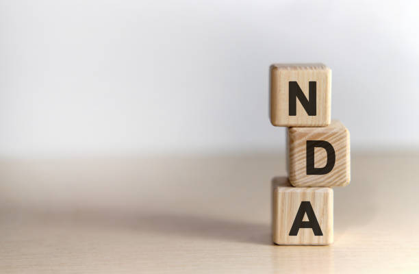 istock NDA - non disclosure agreement - text on wooden cubes, on white background 1216451588