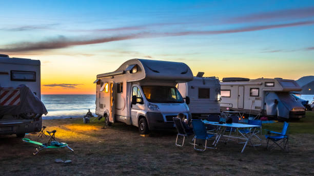 Campers and Motorhomes Campers and Motorhomes overlooking sunset in the Mediterranean sea from their campsite on the beach, Corsica, France camper trailer stock pictures, royalty-free photos & images