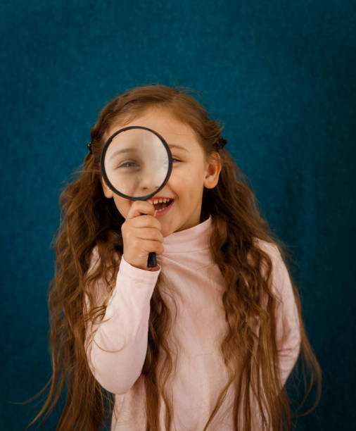 istock little girl with a magnifier 1216452402