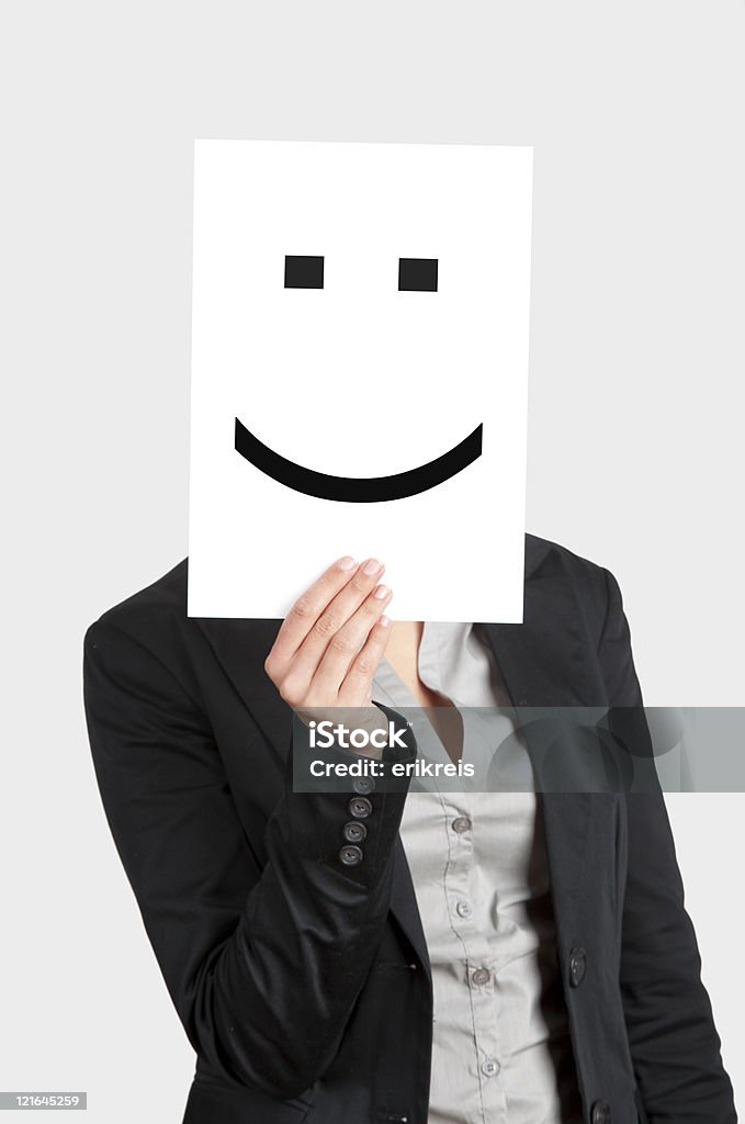 Happy Face Woman showing a blank paper with a smile in front of her face Adult Stock Photo