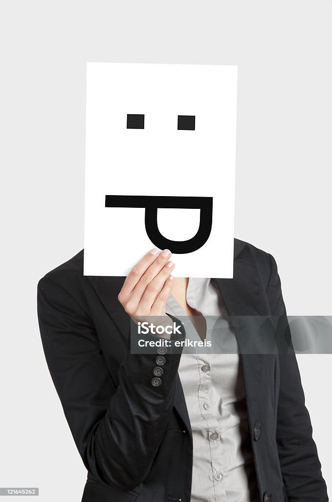 Silly emoticon Woman showing a blank paper with a astonish emoticon in front of her face Adult Stock Photo