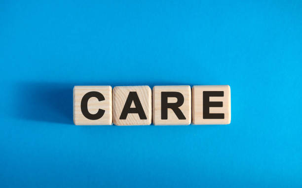 istock CARE - text on wooden blocks, medical concept, blue background 1216452677