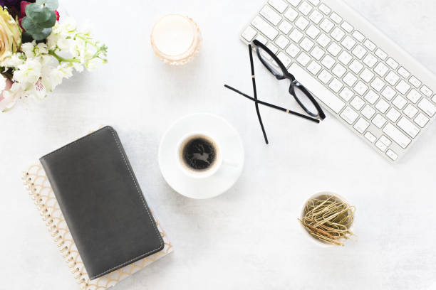 istock Flat lay of computer key baord, note book, coffe and eye glasses 1216453751