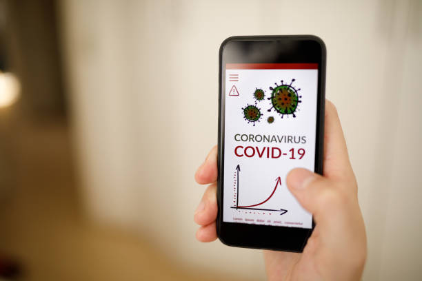 istock Covid-19 news on phone 1216454079