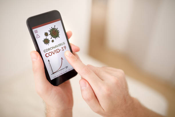 istock Using phone to stay informed about covid-19 1216454081